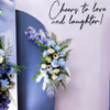 Sun board cutouts and artificial flowers create picture perfect engagement stage