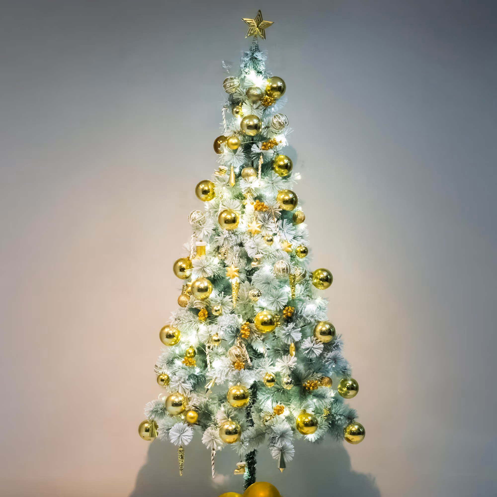 Mixed 100 golden hangings adorn the tree with festive ornaments for celebration.