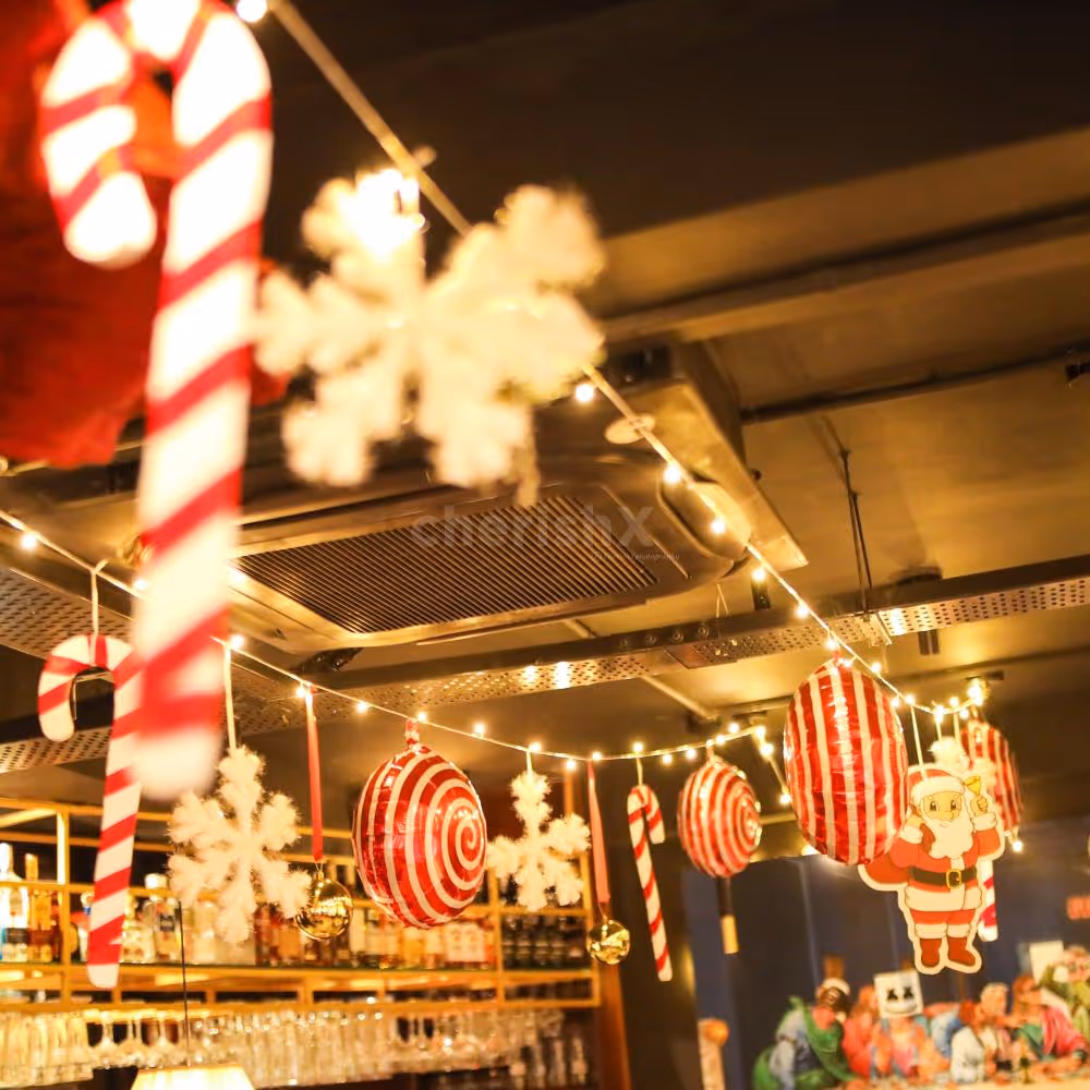 Red candy foil balloons and glittery balls shine brightly as the overhead display