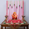 Pink Ganpati decoration with artificial flowers