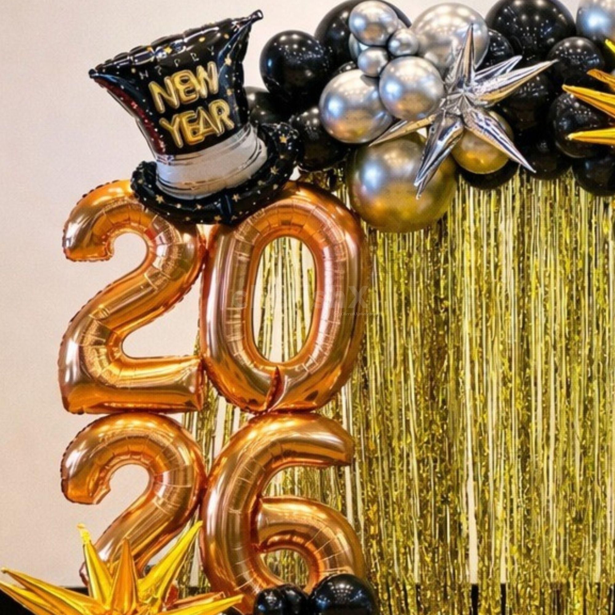 New year bottle and hat foil balloon highlight the playful cheer and mood of the party