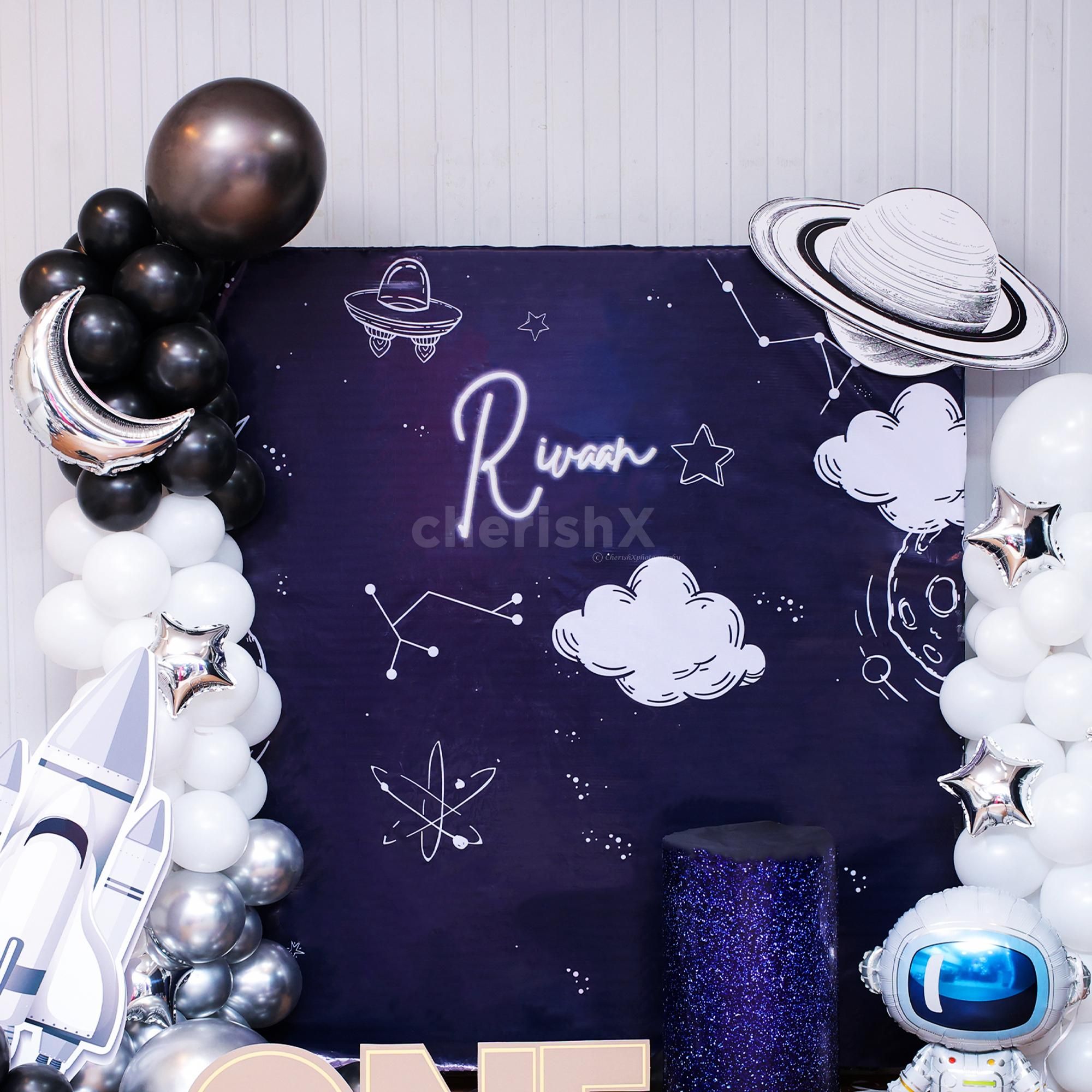 Metallic balloon arch in black, silver, and white celestial harmony.