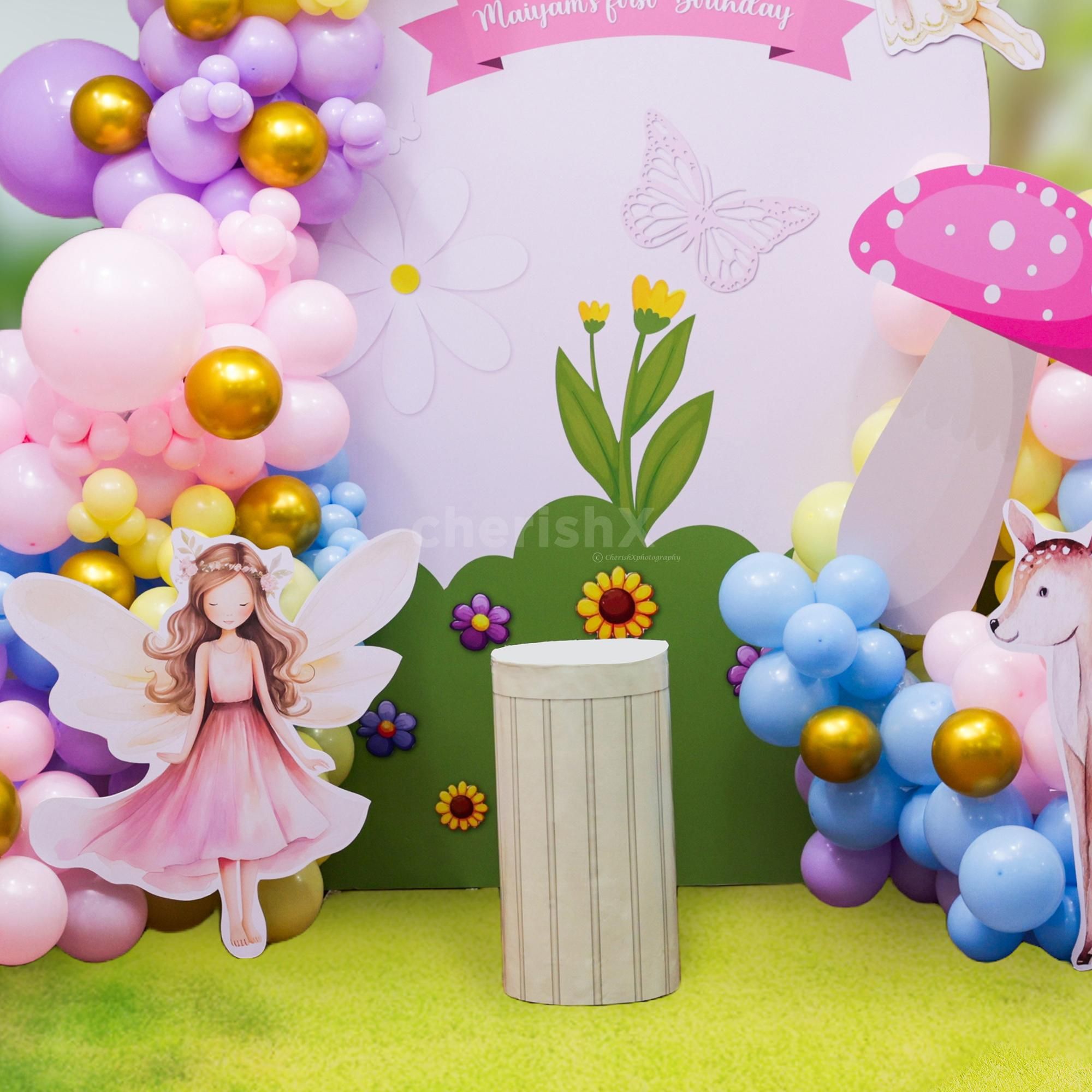 Balloons arch weaves the colours together in a playful backdrop and frames the display