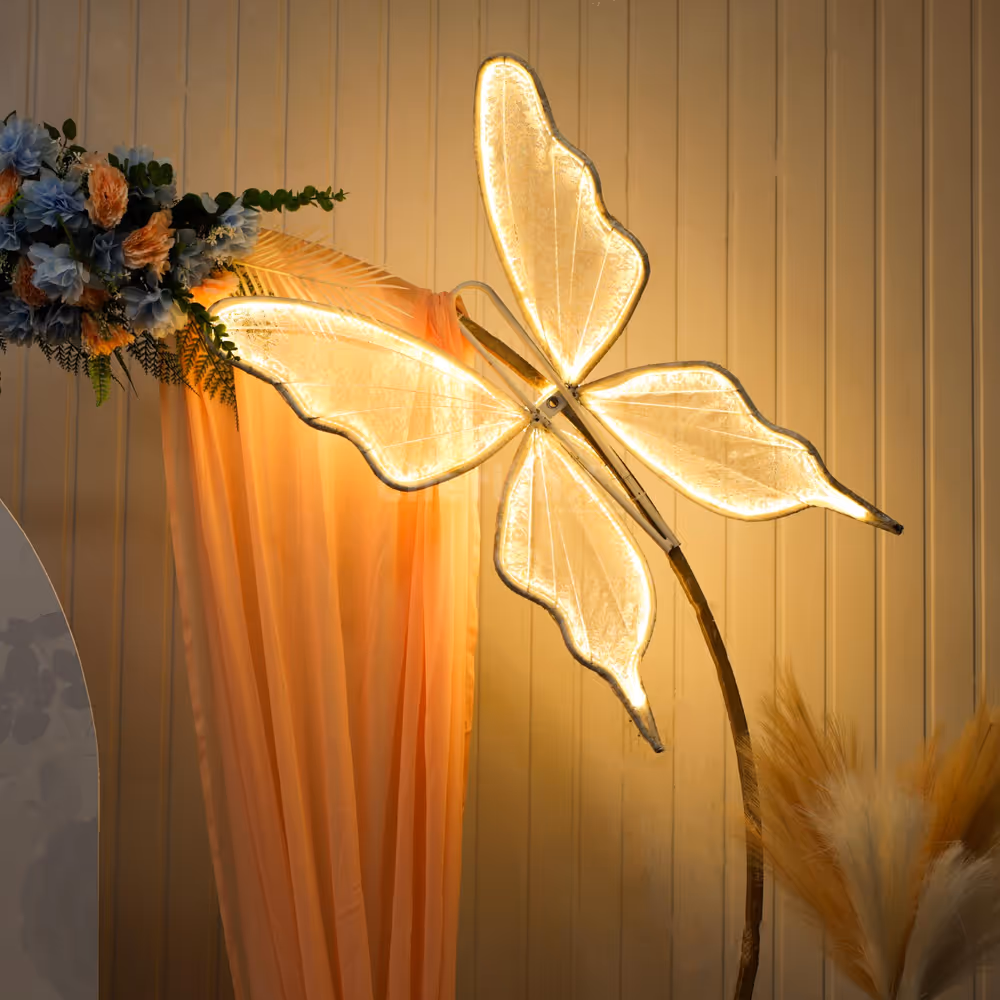 Wow-inspiring engagement decor setup with butterfly feathers lights and flowers