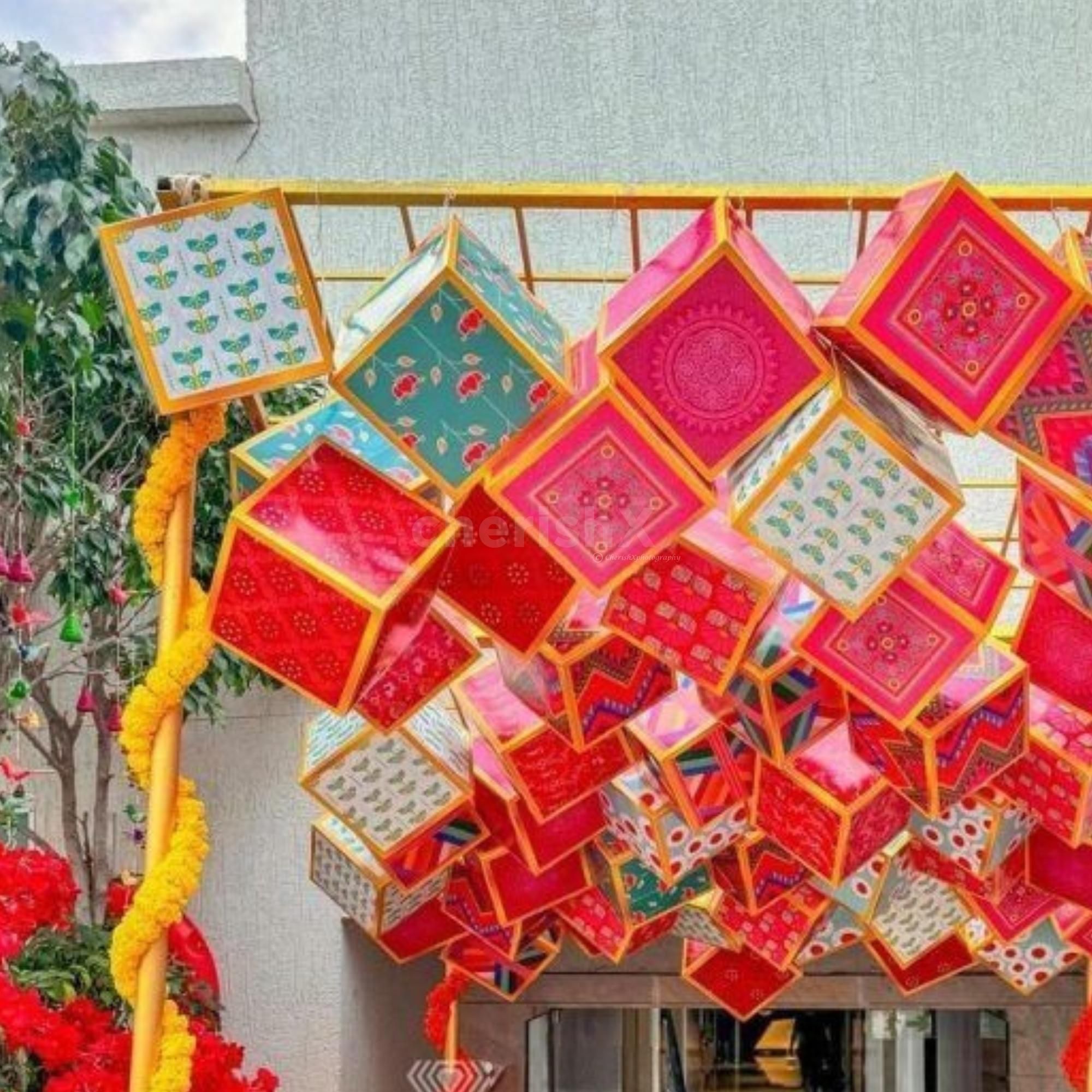 Vivid ceiling cubes bring playful energy to festive interiors.