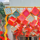 Vivid ceiling cubes bring playful energy to festive interiors.