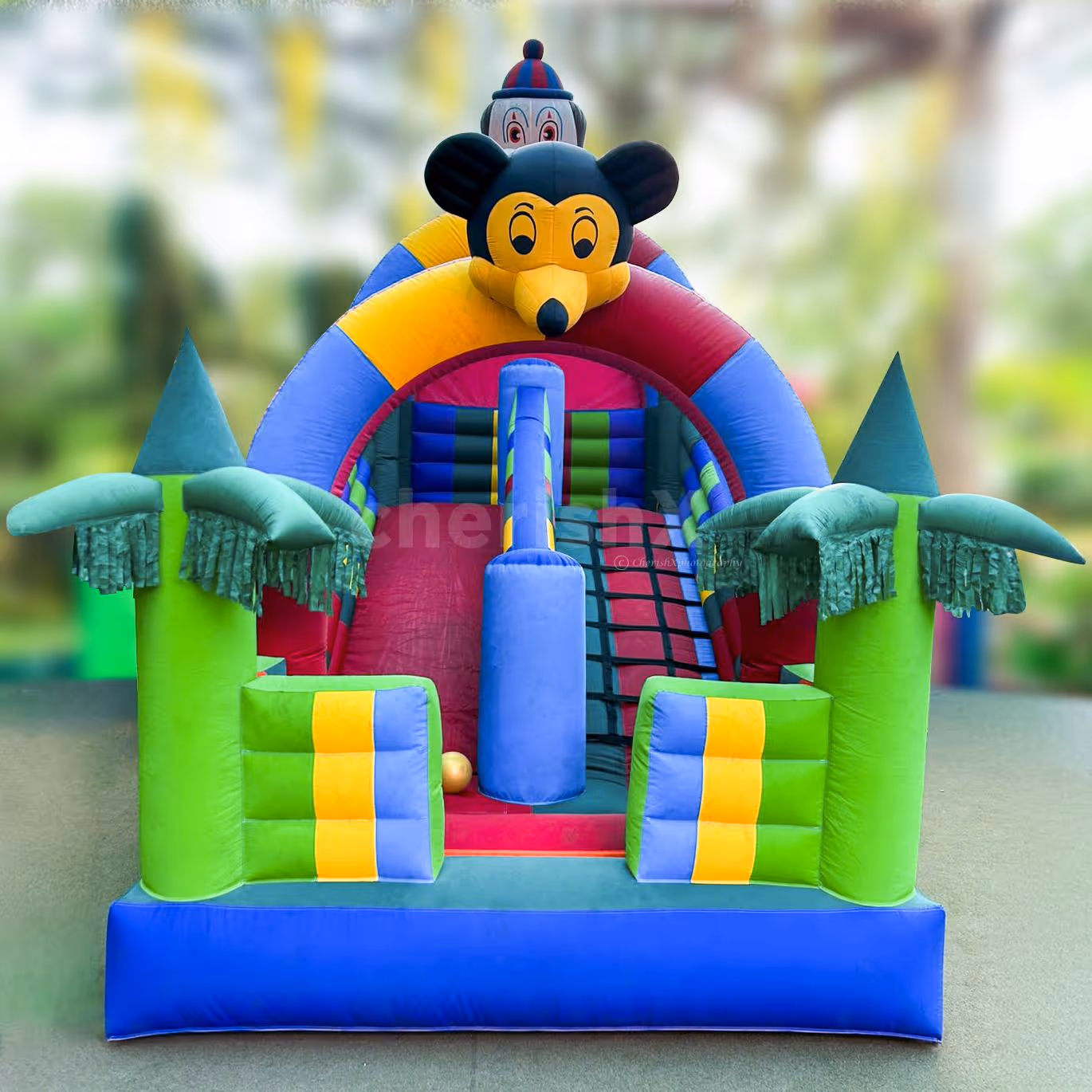 Columns in the shape of palm trees and a huge mouse head make a cartoonish atmosphere.