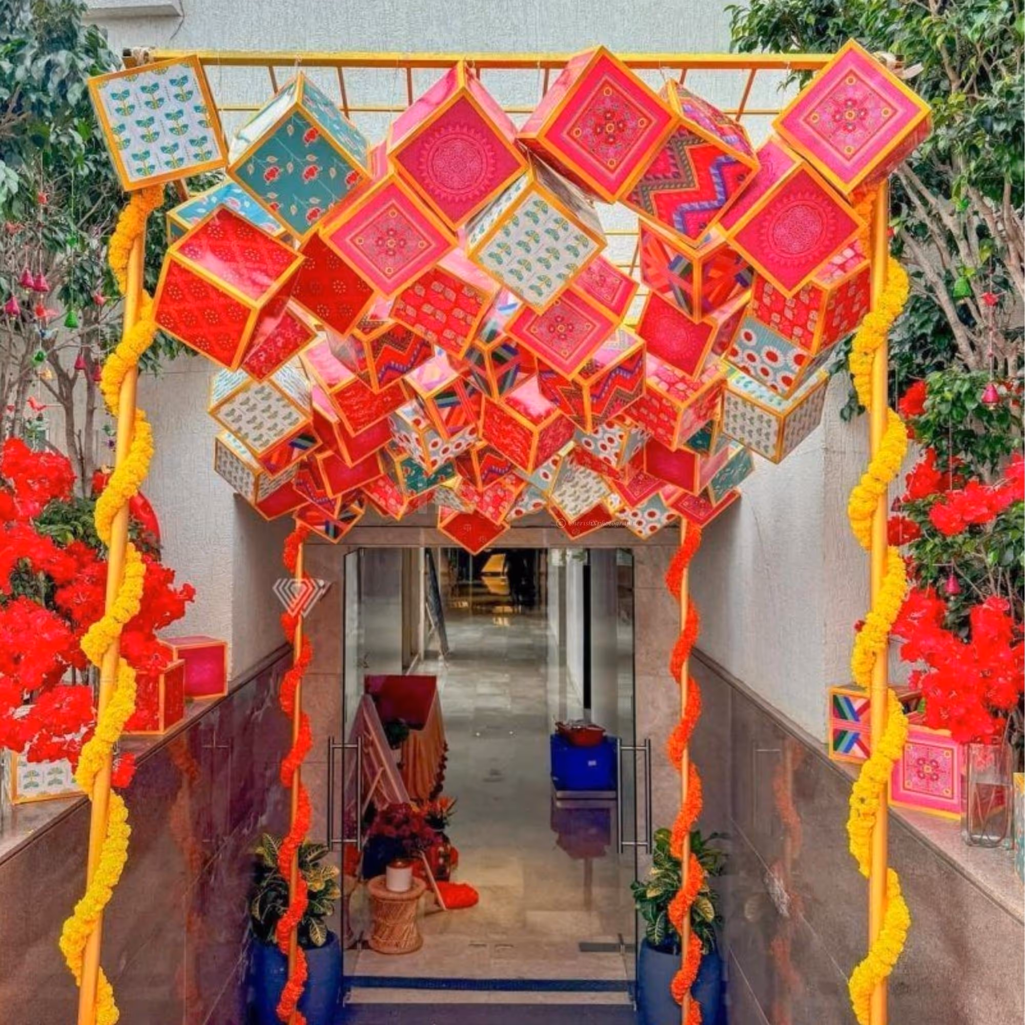 Floral strands add softness to the bold ceiling display.