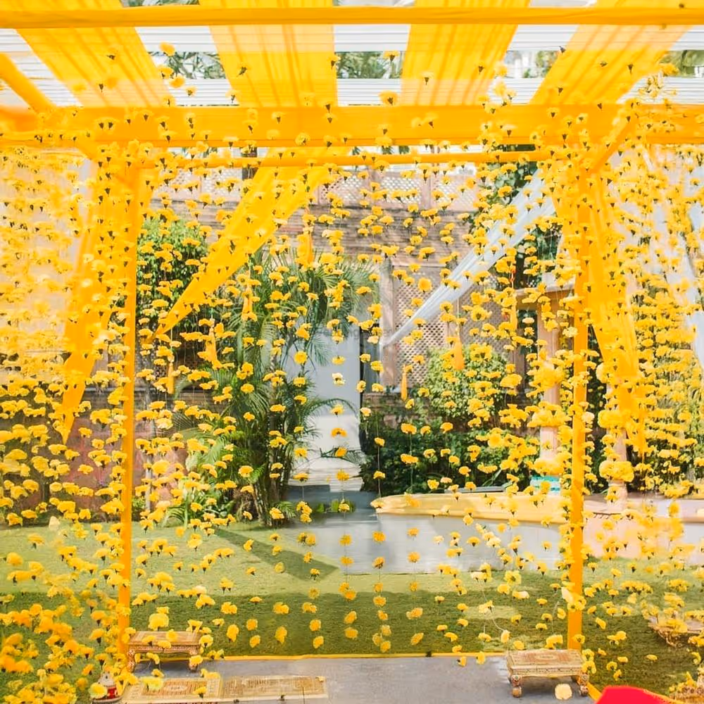 Golden floral mandap brings haldi vibes to life.