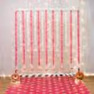 White garland arching on the stand frames Ganesh's space well