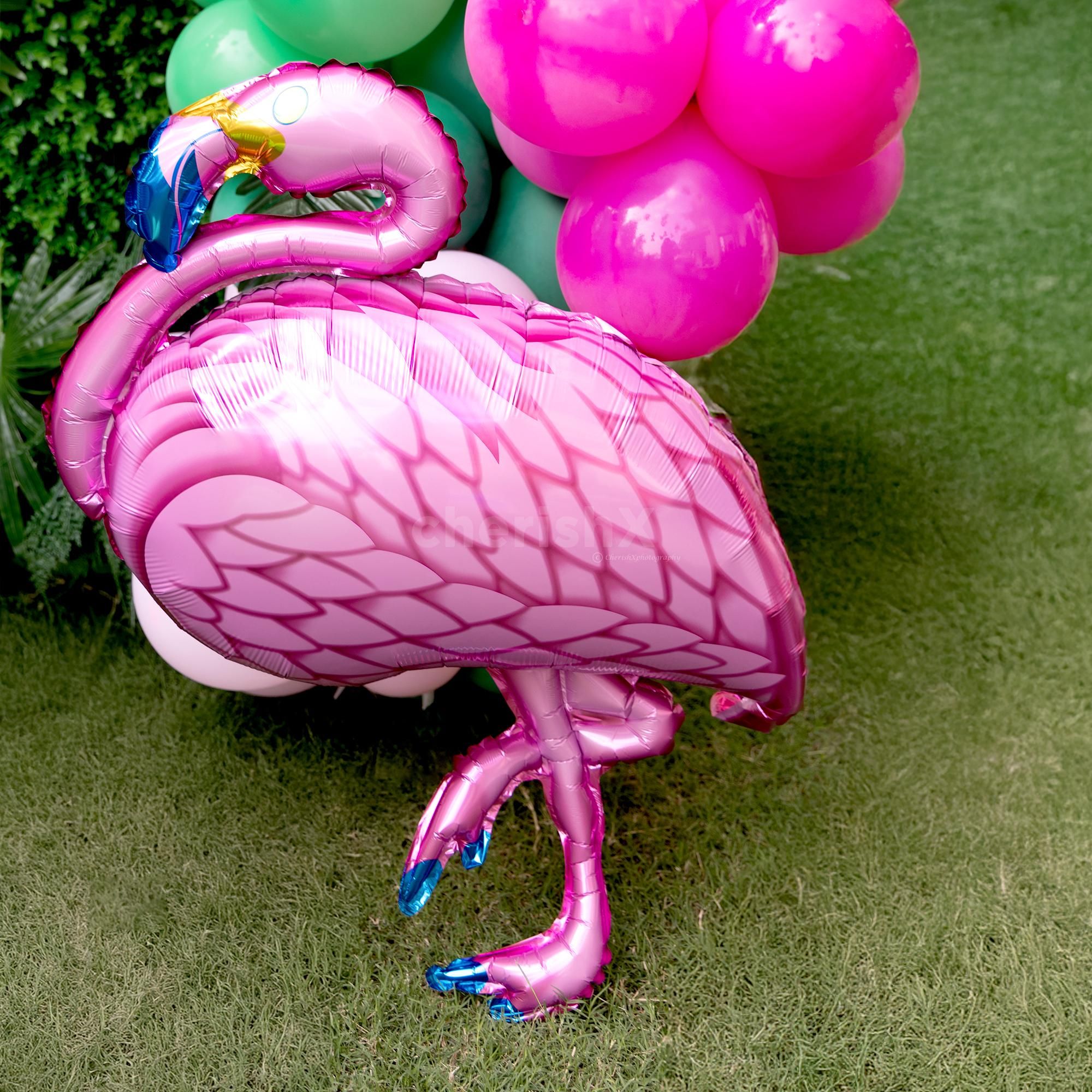 Vibrant balloon arch in pink, gold, and green for that ooh-la-la effect.