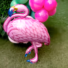 Vibrant balloon arch in pink, gold, and green for that ooh-la-la effect.