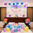 Fairy lights sparkle around a cozy "Welcome Baby" bunting.