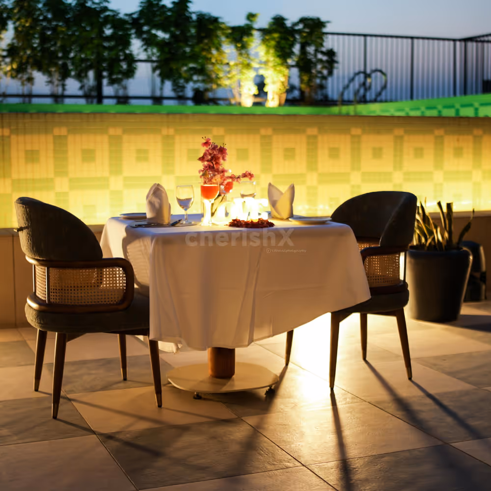 Elegantly decorated table with flowers, lights, and candles on the poolside lower deck.