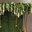 White orchid and money plant bell hangings bring in sophistication and delicacy