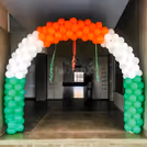Balloons pillars flex banner and green flex floor infuse festive energy in the space