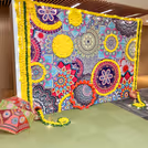 Green pan strings add depth and balance the decor, besides their religious importance