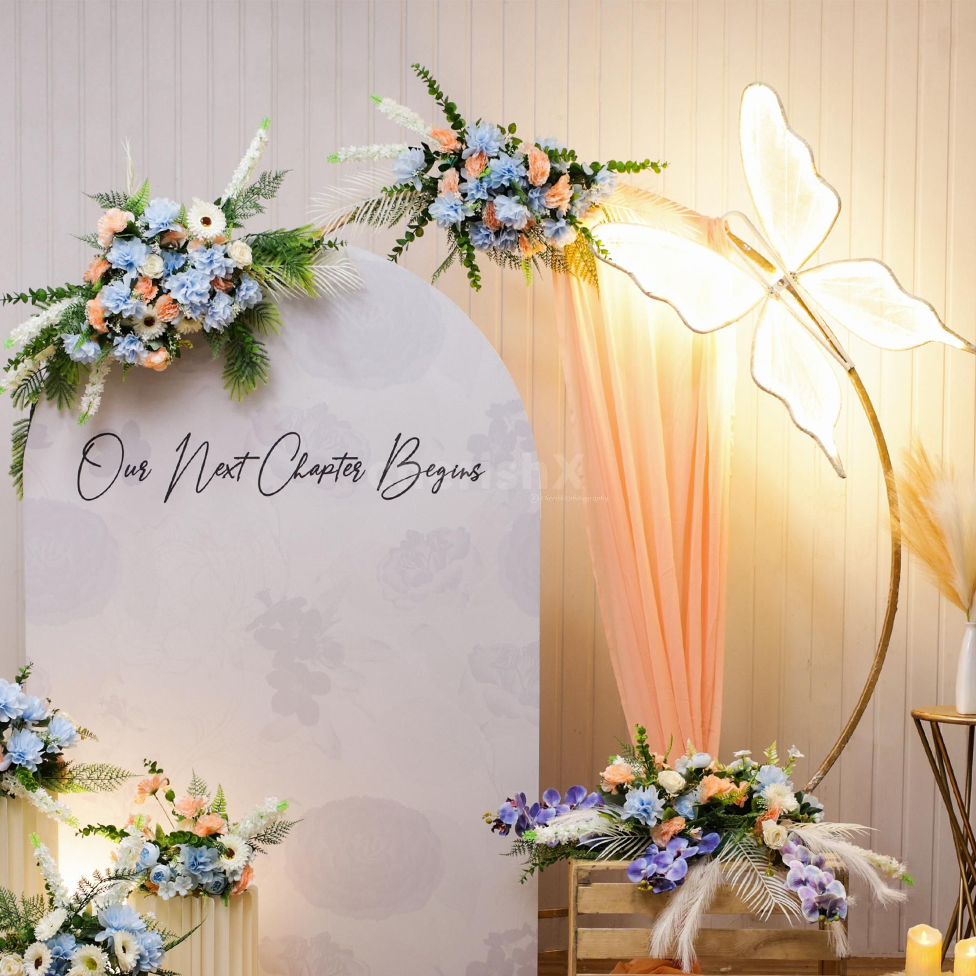 Engagement perfect backdrop with beautiful artificial flowers, a butterfly and more.