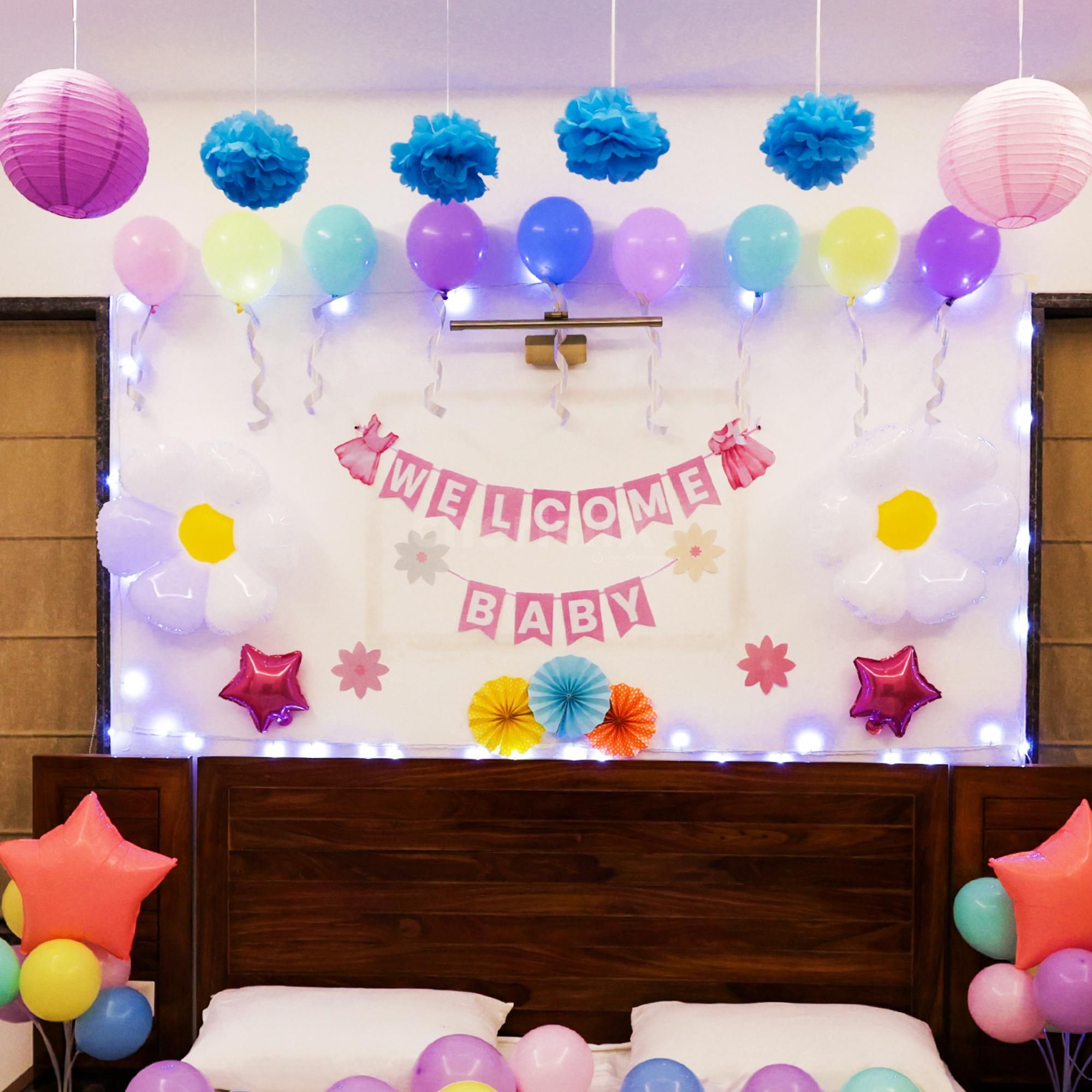 A pastel balloon bed arrangement brings gentle happiness to your baby's arrival.