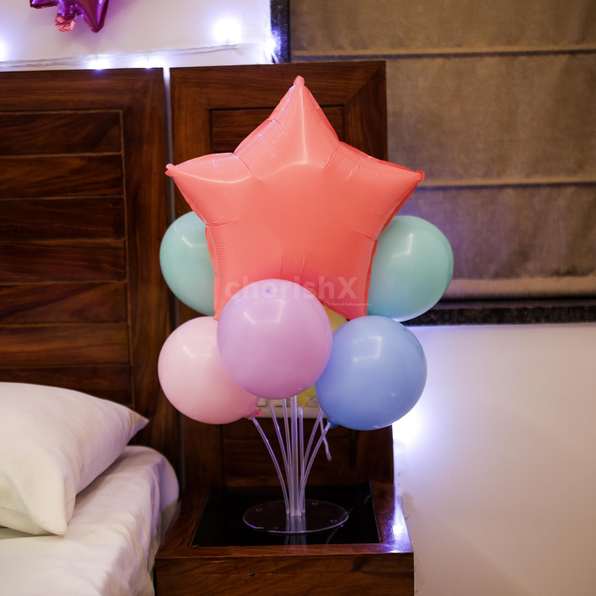 Balloon stands on both sides provide balance and color to the theme.
