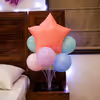Balloon stands on both sides provide balance and color to the theme.