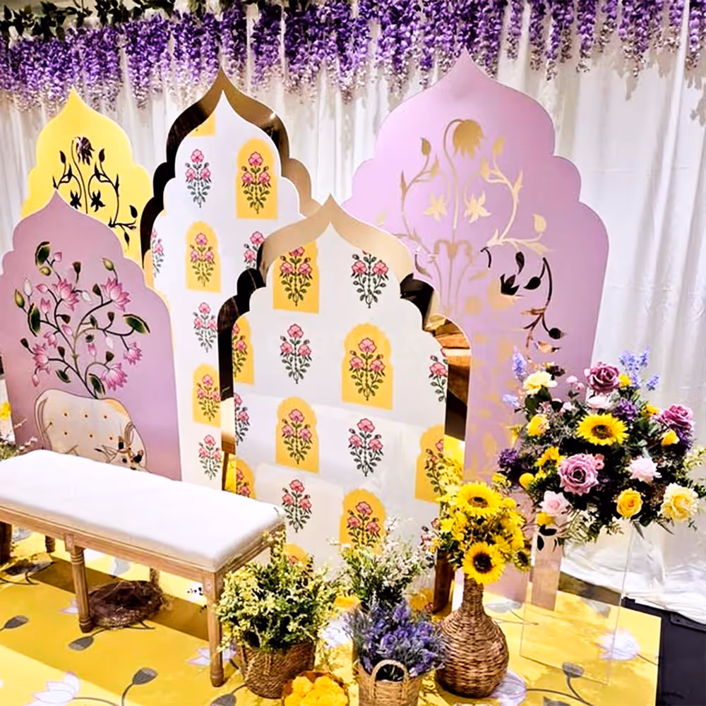 A cute haldi-mehendi chair amidst flowers and props.