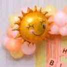 Sunshine foil balloons provide bright accents.