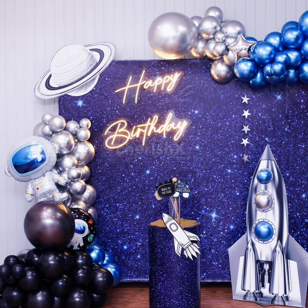 A dramatic balloon arch in metallic tones and polka dot pops.
