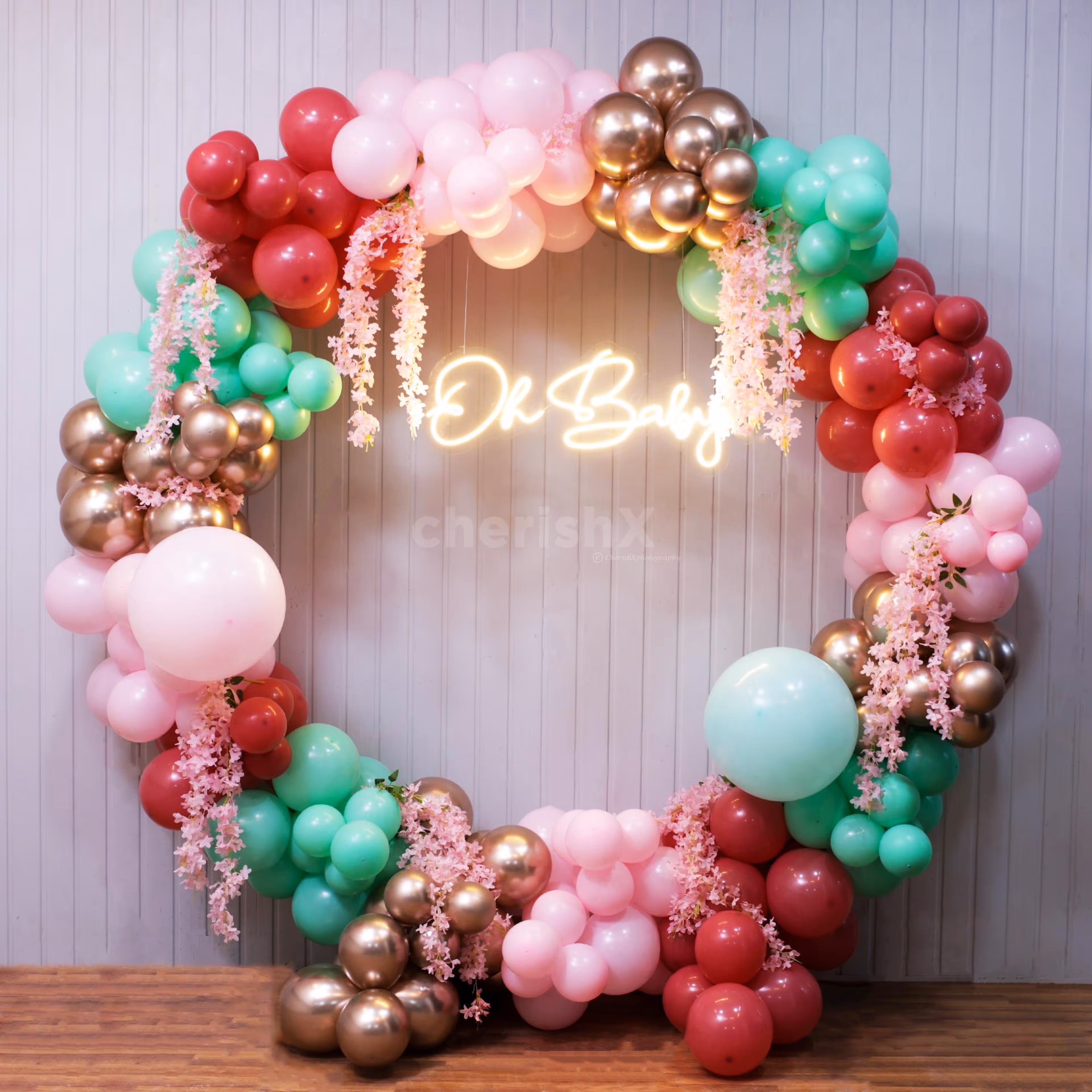 Cascading pink and pastel tones create a dreamy baby shower backdrop