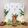 Banana leaves at the base of the puja area relate decor to the tradition