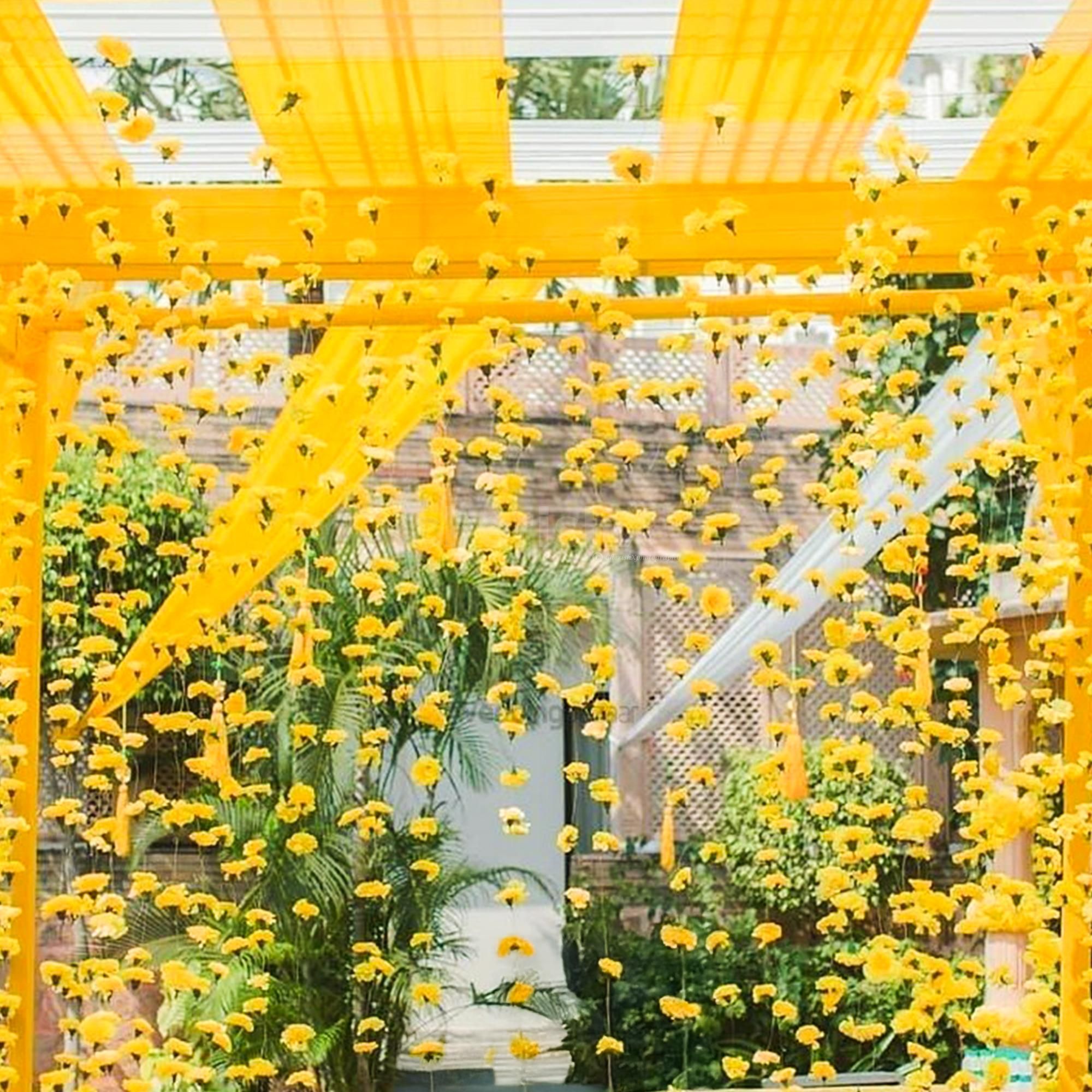 Floating marigold strings create a dreamy floral shower.