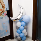 Blue and grey balloons create an elegant baby-themed entrance arrangement.