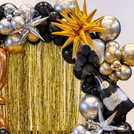 Golden foil frill curtains create a waterfall effect on the wall and add glamour in selfies