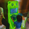 Children play racing games with a working steering wheel for an actual car experience