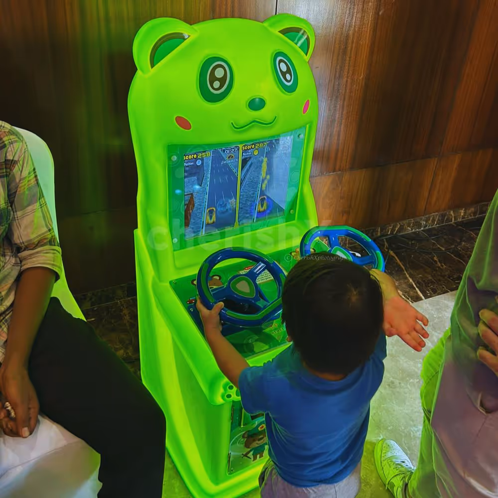 Children play racing games with a working steering wheel for an actual car experience