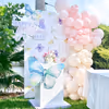 Pastel pink balloon arch surrounds a Mother's Day banner.