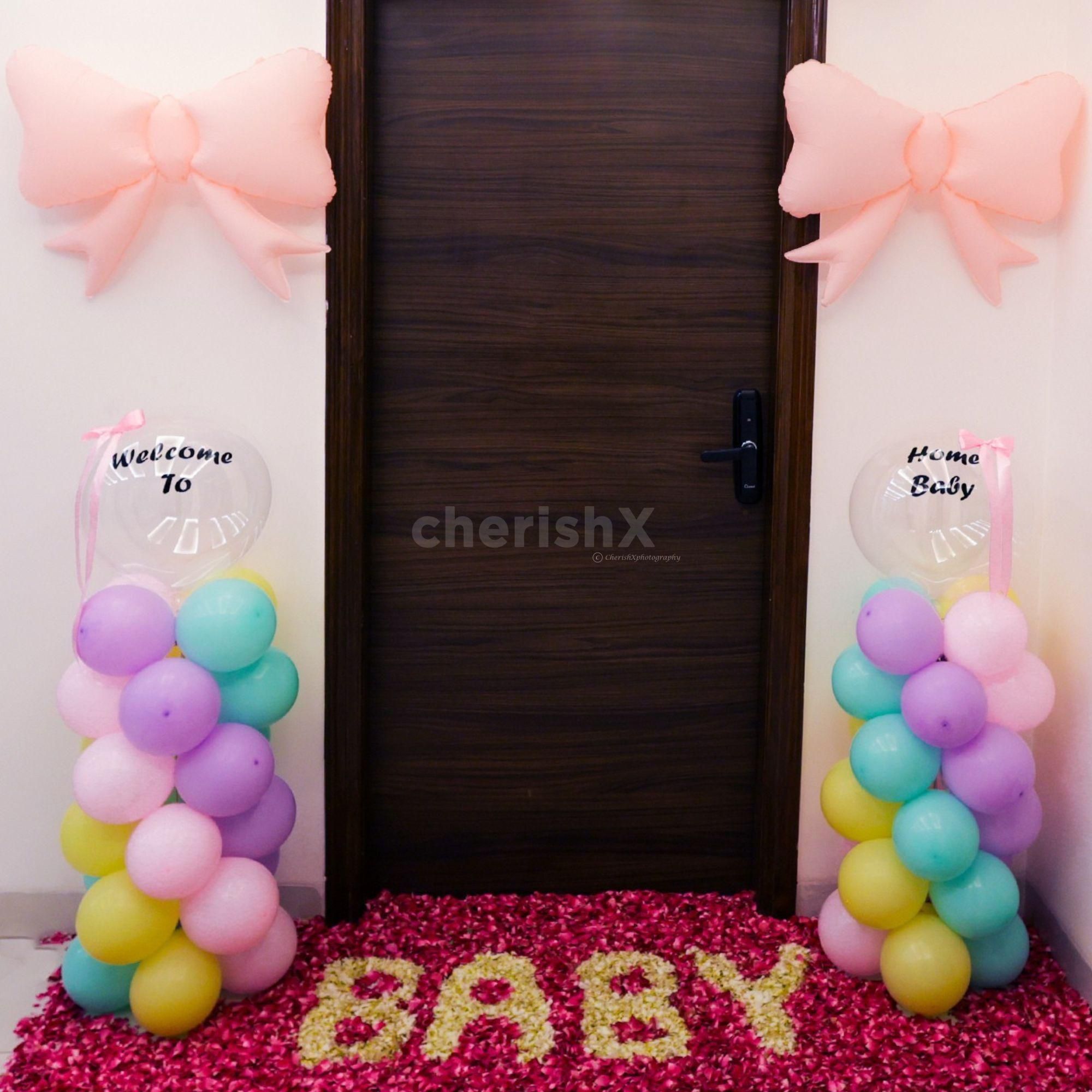 Floral rangoli with "BABY" spelled out in petals adds to the warm welcome.