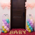 Floral rangoli with "BABY" spelled out in petals adds to the warm welcome.
