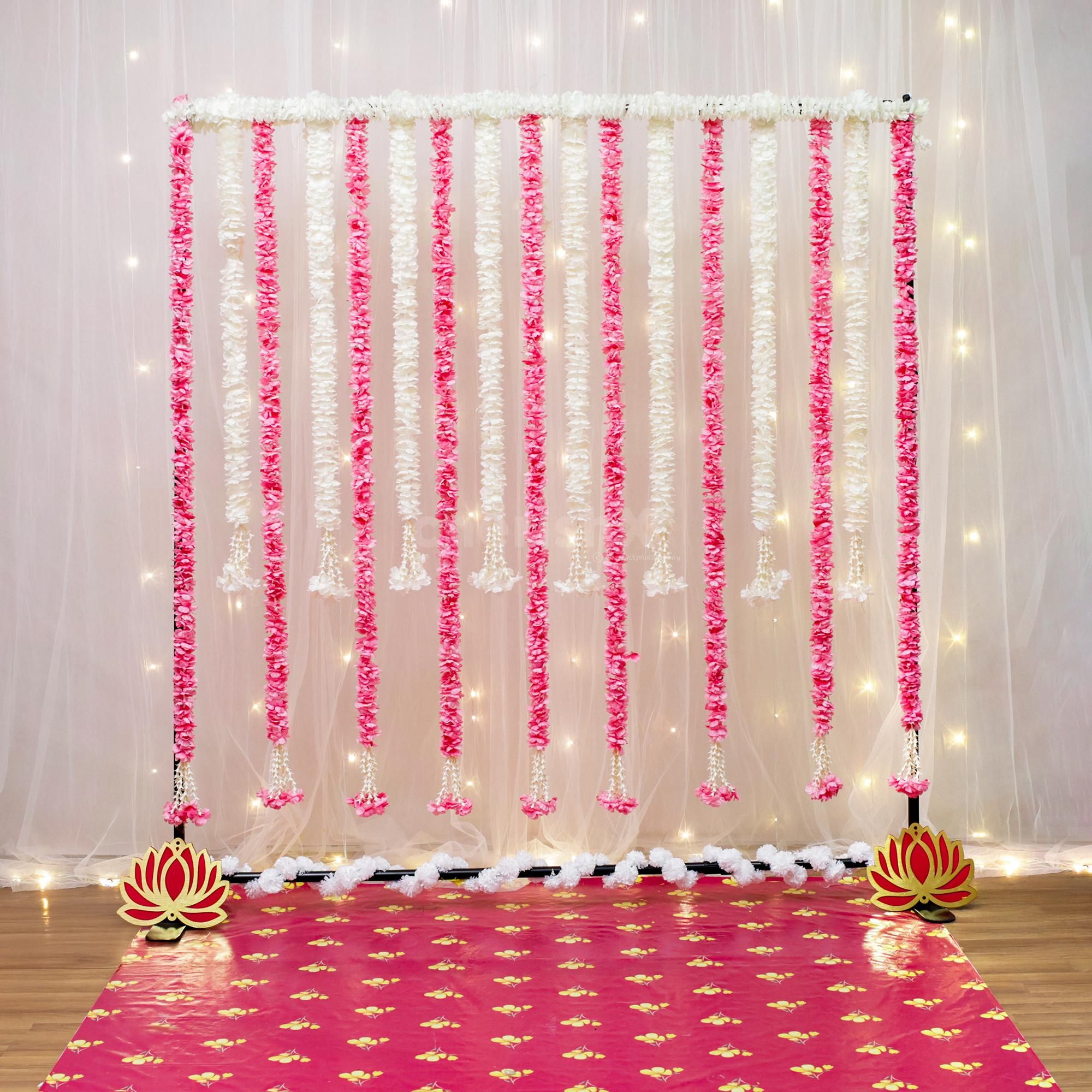 White garland arching on the stand frames Ganesh's space well