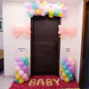 The pastel balloon arch lends a whimsical touch at the entrance.