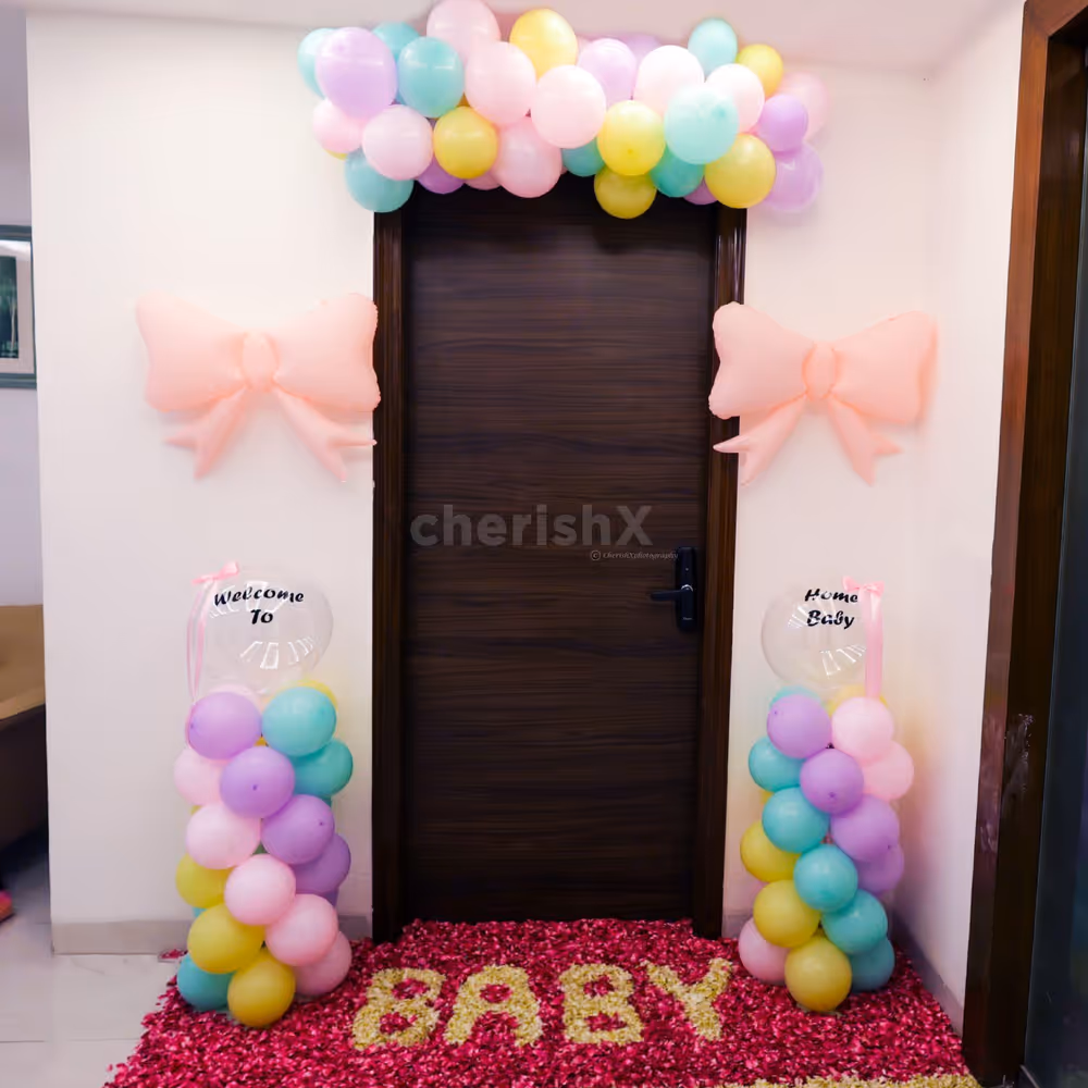 The pastel balloon arch lends a whimsical touch at the entrance.