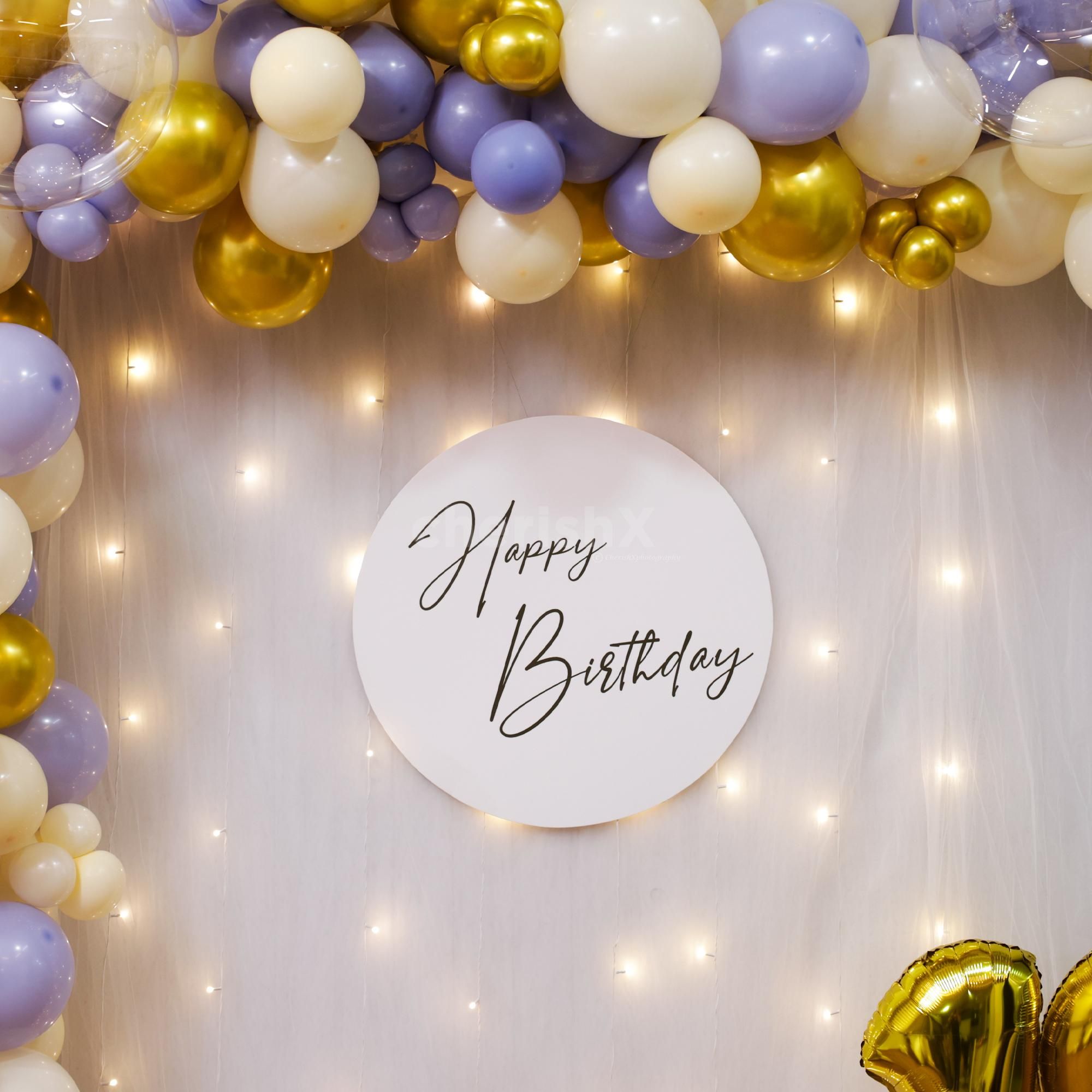 A playful backdrop of balloons and fairy light draws attention instantly