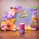Two oversized macaron balloons add playful dimension to the kids’ favourite decor
