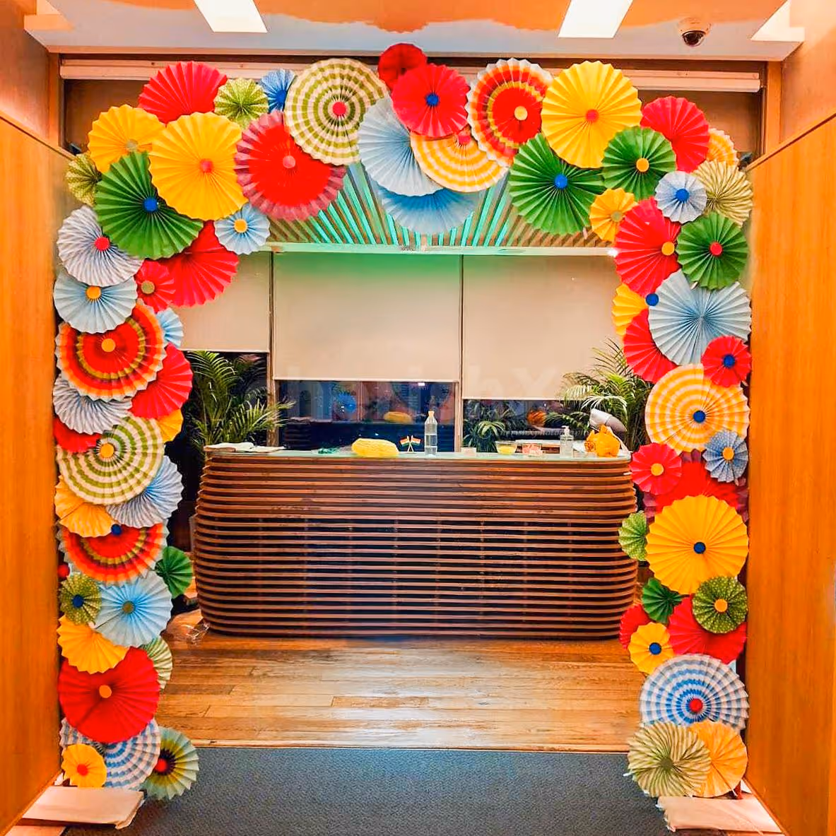 Layered multicoloured paper rosettes bring texture and life to the reception area