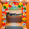 Layered multicoloured paper rosettes bring texture and life to the reception area