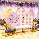 Royal pastel arch panels with floral paintings form a dreamy background.