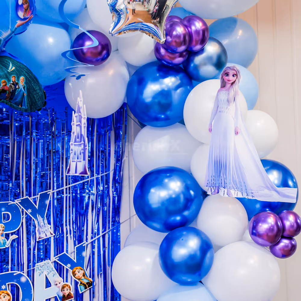 Ceiling balloon bunches and foil stars swirl with balloon arch for birthday magic