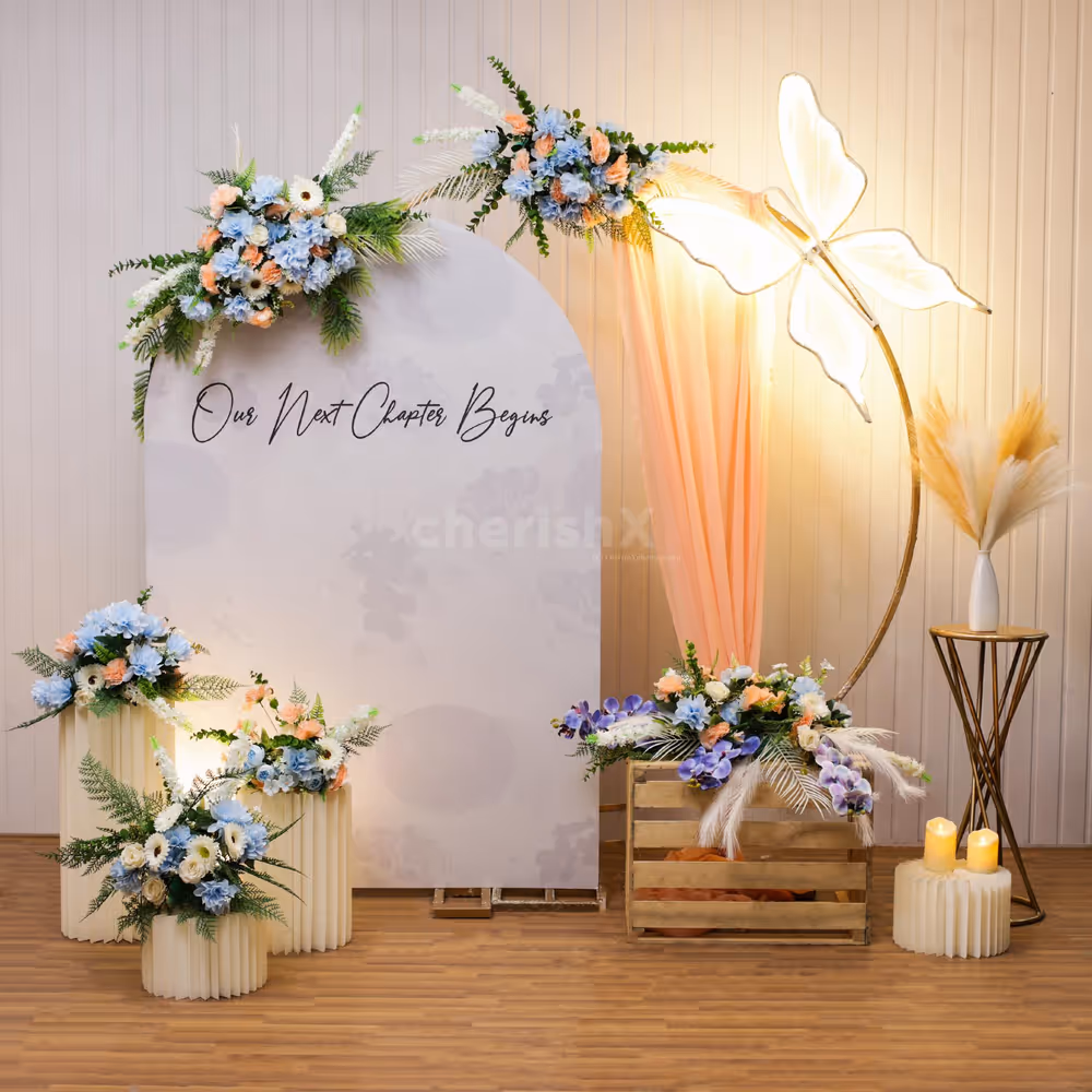 Butterfly along with bunches of artificial flowers creates vibrant engagement decor.
