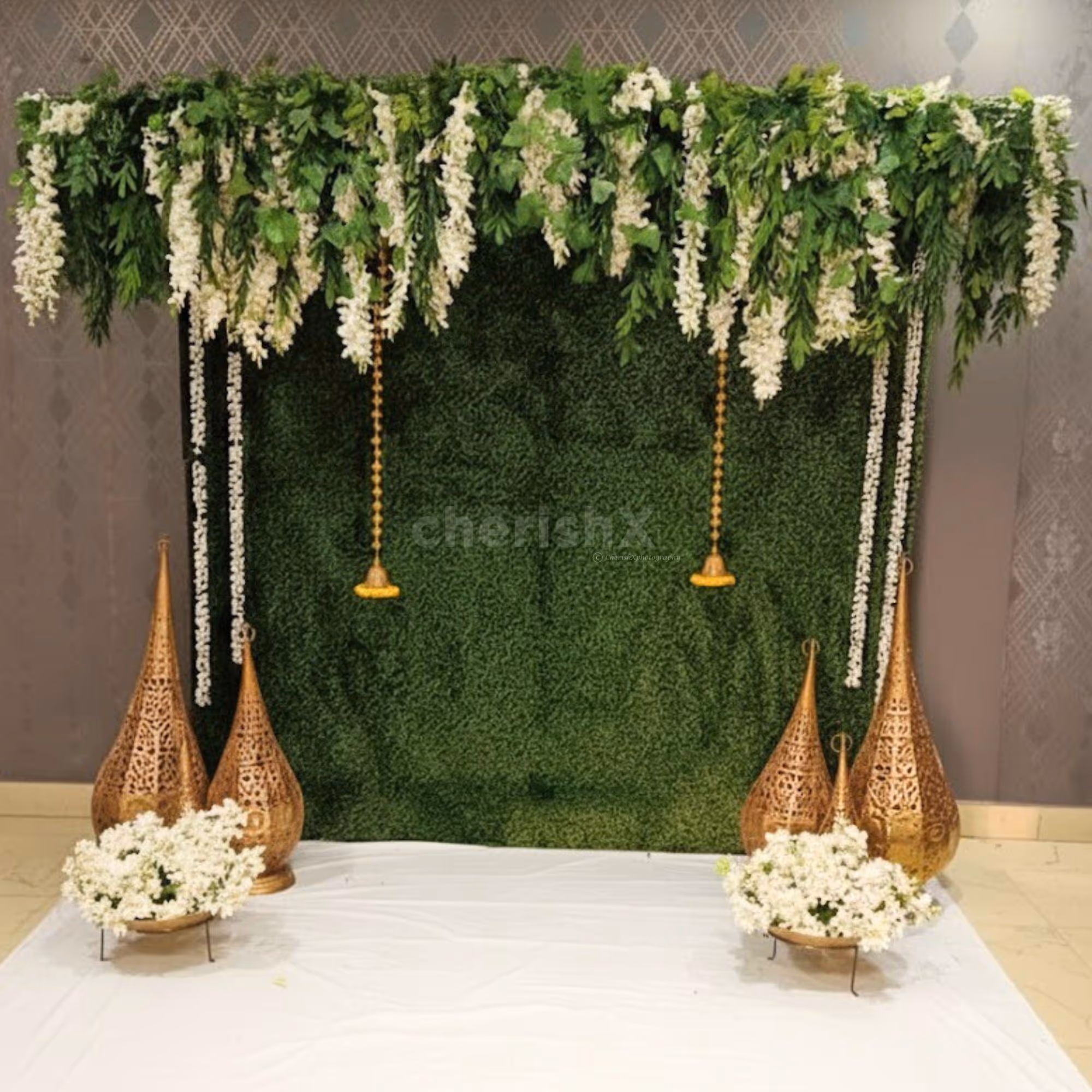 Wattle leaves add natural texture to the green wall decor, adding warmth