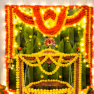 Yellow flowers, lights, and bells together makes a bright, festive cradle setup